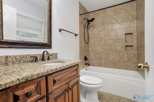 full bathroom with tile patterned flooring, toilet, vanity, and tiled shower / bath