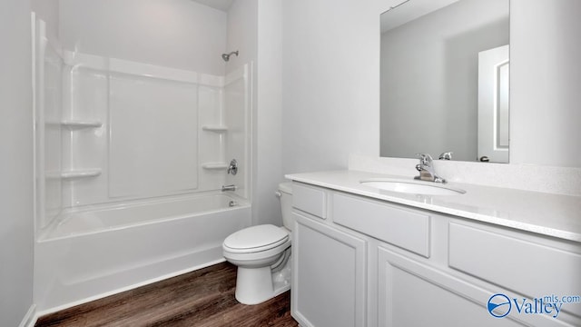 full bathroom with vanity, hardwood / wood-style floors, shower / bathing tub combination, and toilet