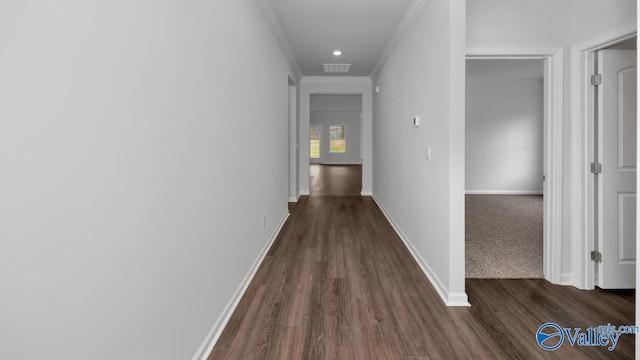 corridor with dark hardwood / wood-style floors and ornamental molding