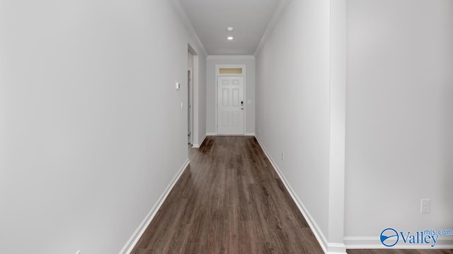 hall with dark hardwood / wood-style floors and ornamental molding