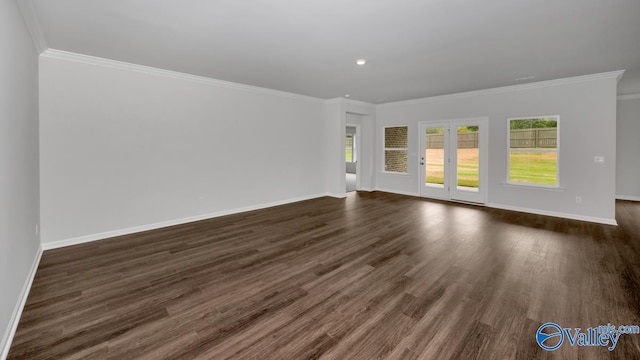 spare room with dark hardwood / wood-style floors and crown molding