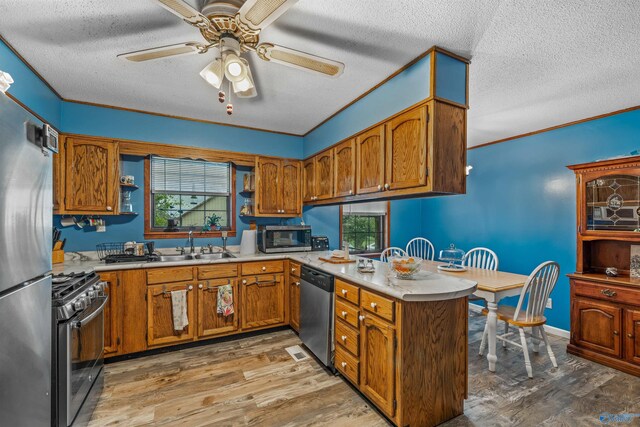 living room featuring wood walls, carpet floors, a textured ceiling, and ceiling fan