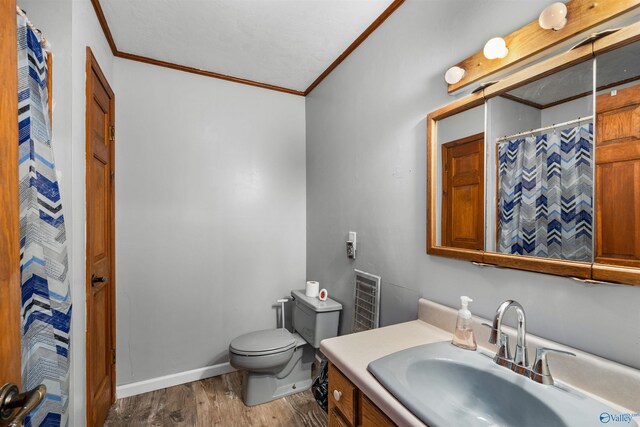 bedroom featuring ceiling fan, dark hardwood / wood-style flooring, a textured ceiling, ornamental molding, and a closet