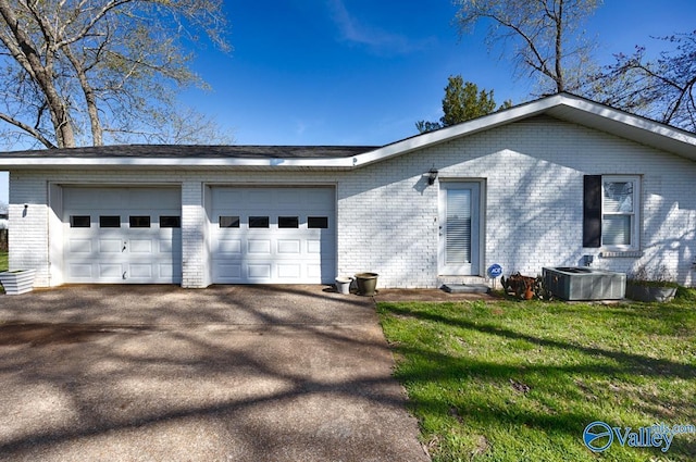 7228 Old Railroad Bed Rd, Toney, AL 35773 - view of front facade featuring aphalt driveway, an attached garage, and brick siding