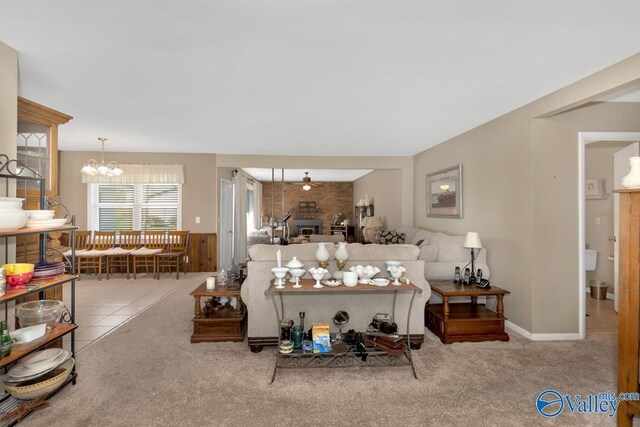 carpeted living room with an inviting chandelier