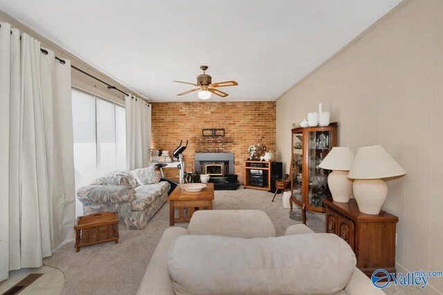 carpeted living room featuring a fireplace, brick wall, ceiling fan, and a wood stove