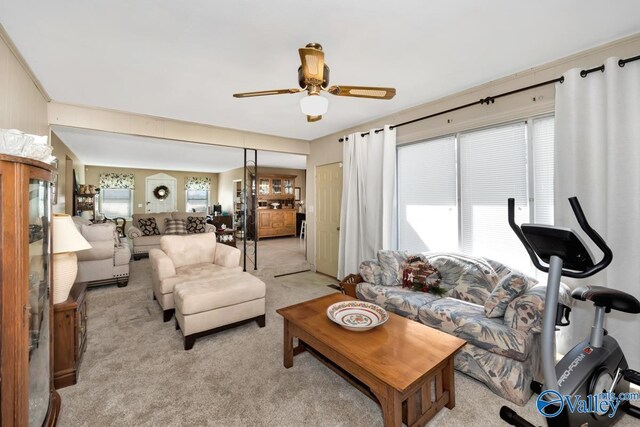 living room with ceiling fan and light colored carpet