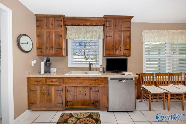 kitchen with sink, dishwasher, and light tile patterned floors