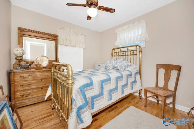 bedroom with light hardwood / wood-style flooring and ceiling fan