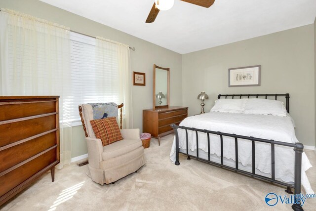 bedroom featuring light colored carpet and ceiling fan