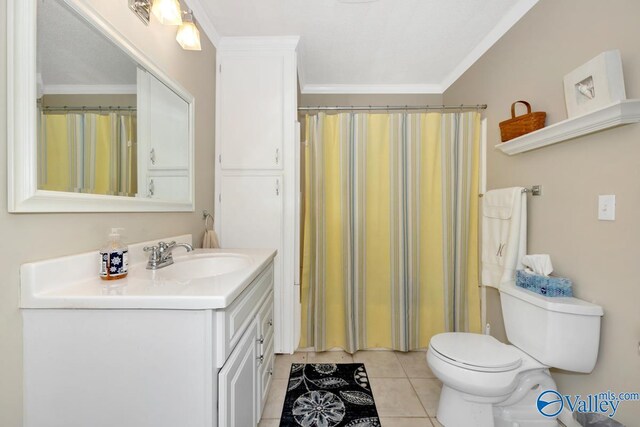 bathroom featuring vanity, toilet, crown molding, and tile patterned flooring