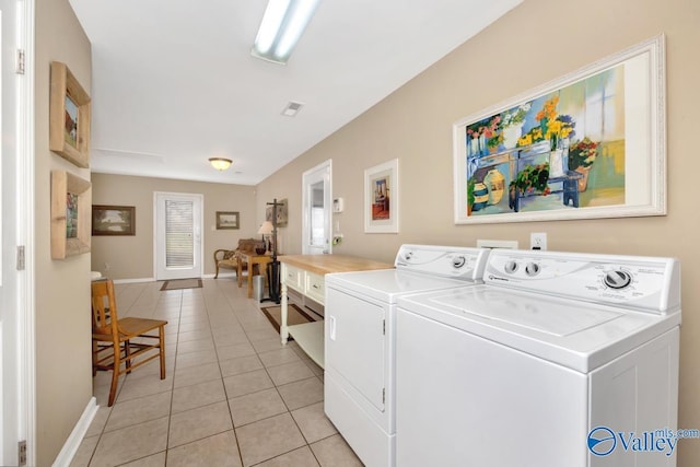 7228 Old Railroad Bed Rd, Toney, AL 35773 - laundry room with light tile patterned flooring, visible vents, washing machine and dryer, and baseboards