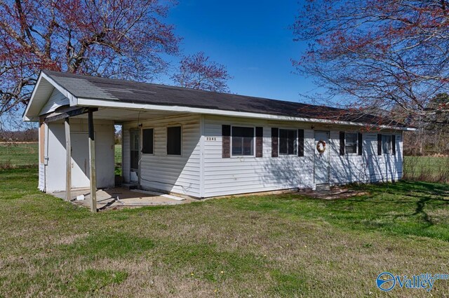 back of house with a lawn