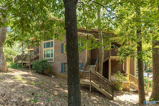 2043 Woodlawn Dr SW Unit 2043, Huntsville, AL 35802 - back of house featuring stairway and brick siding