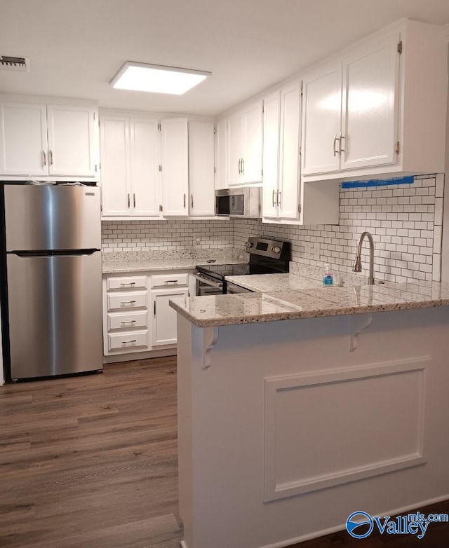 2043 Woodlawn Dr SW Unit 2043, Huntsville, AL 35802 - kitchen with stainless steel appliances, white cabinetry, and light stone counters