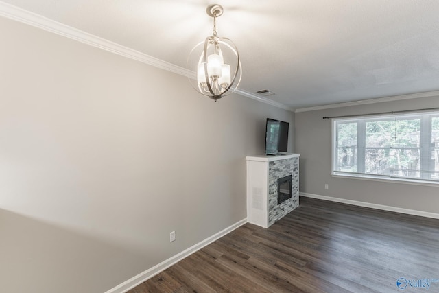 2043 Woodlawn Dr SW Unit 2043, Huntsville, AL 35802 - unfurnished living room with ornamental molding, a chandelier, dark wood-type flooring, and a stone fireplace