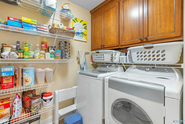 laundry room featuring separate washer and dryer and cabinet space