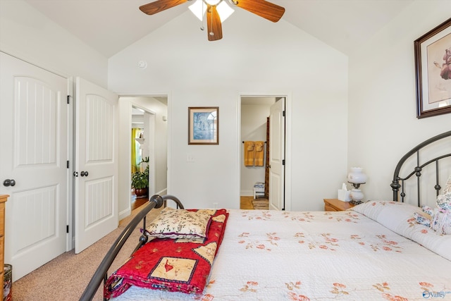 bedroom with light carpet, vaulted ceiling, a ceiling fan, and ensuite bathroom