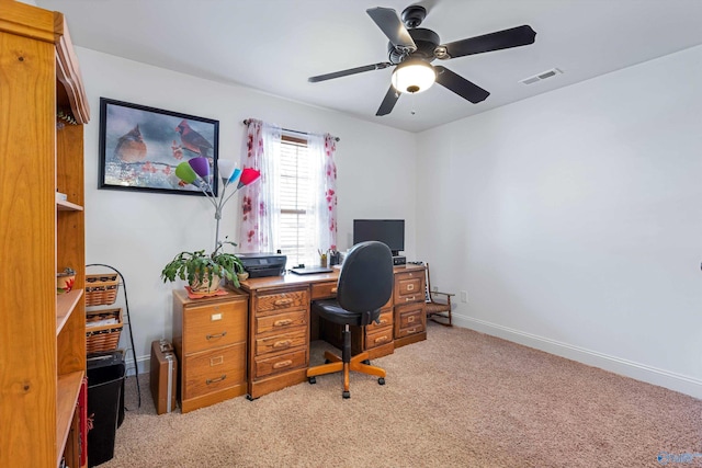 home office featuring light carpet, ceiling fan, visible vents, and baseboards