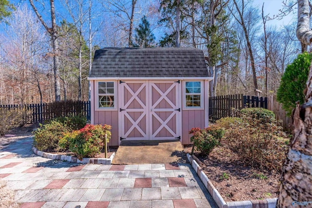 view of shed with a fenced backyard