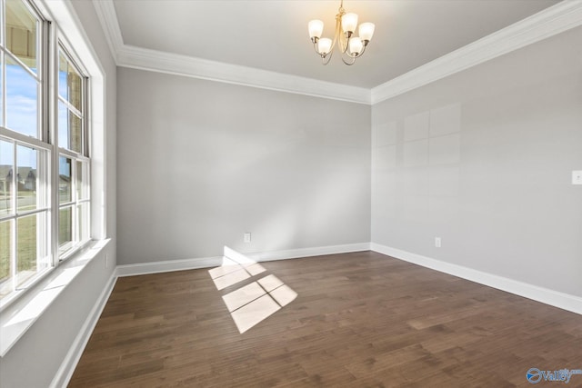 empty room with ornamental molding, plenty of natural light, dark wood-type flooring, and an inviting chandelier