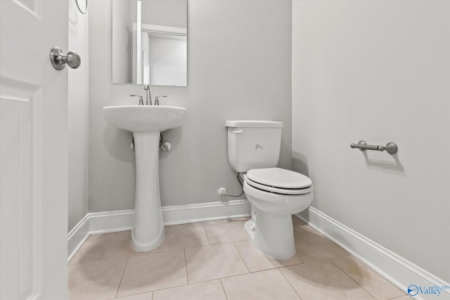 bathroom with tile patterned floors and toilet