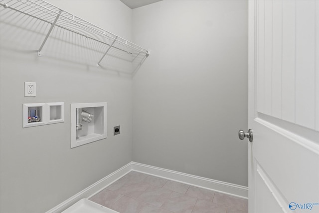 washroom with washer hookup, hookup for an electric dryer, and light tile patterned floors