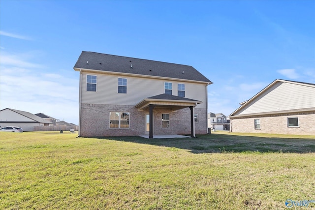 rear view of house featuring a patio and a lawn