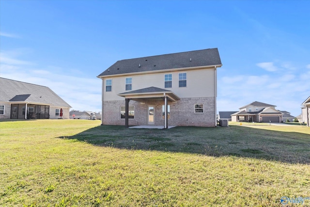 back of property with central AC unit, a lawn, and a patio