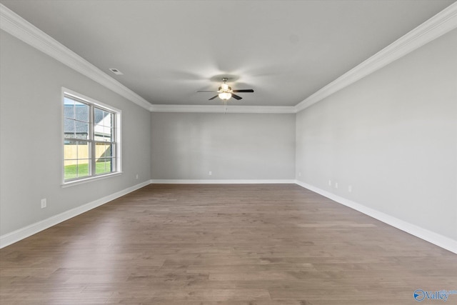 spare room featuring crown molding, dark wood-type flooring, and ceiling fan