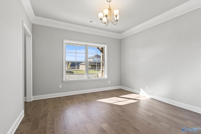 spare room with an inviting chandelier, dark hardwood / wood-style floors, and crown molding