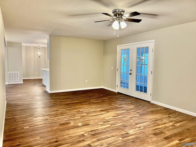 empty room with visible vents, french doors, a ceiling fan, and wood finished floors