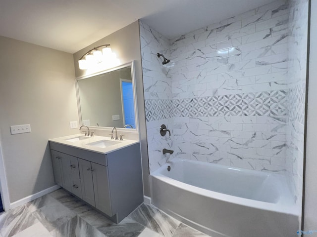 bathroom with marble finish floor, double vanity,  shower combination, and a sink