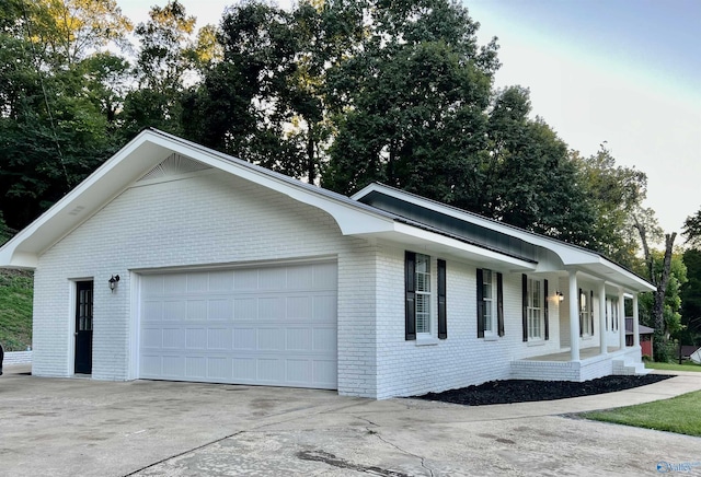 view of front facade with driveway and brick siding