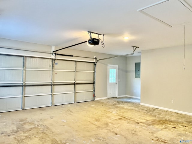 garage with electric panel, a garage door opener, and baseboards