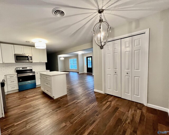 kitchen featuring decorative backsplash, dark wood-style flooring, white cabinets, visible vents, and stainless steel appliances