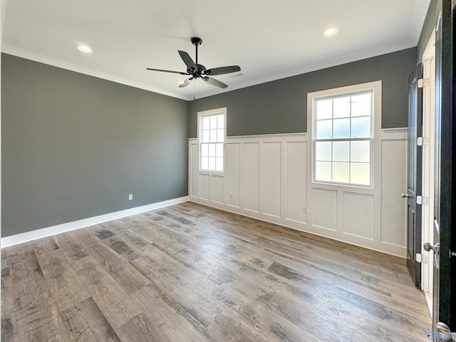 unfurnished room featuring crown molding, ceiling fan, and light hardwood / wood-style floors