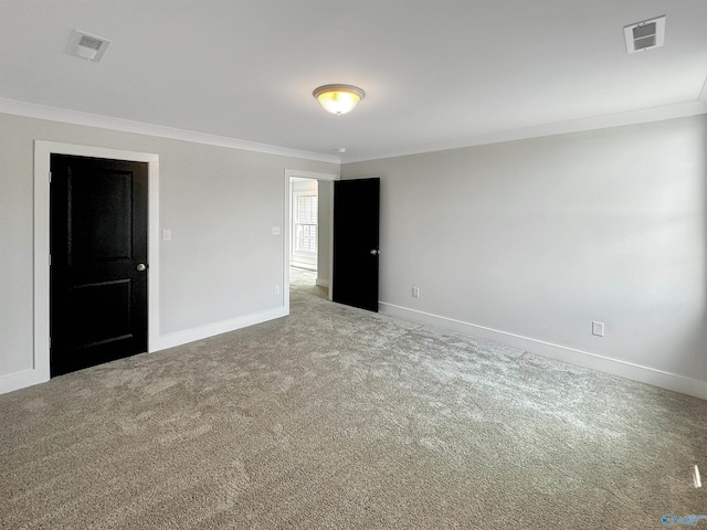 empty room featuring ornamental molding and carpet floors