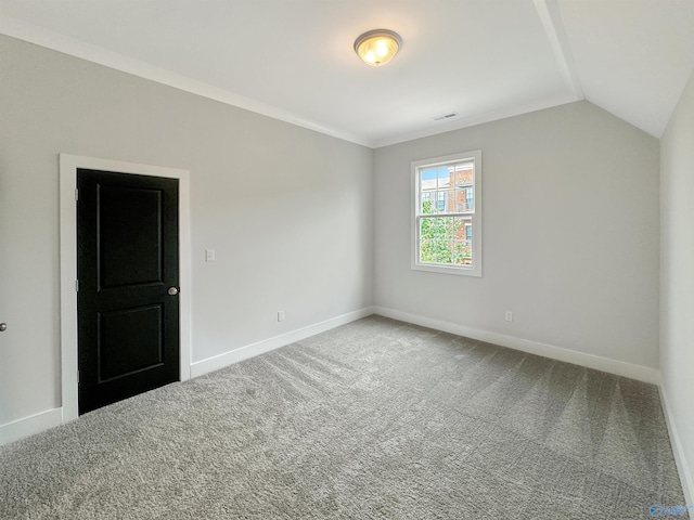 empty room featuring lofted ceiling and carpet