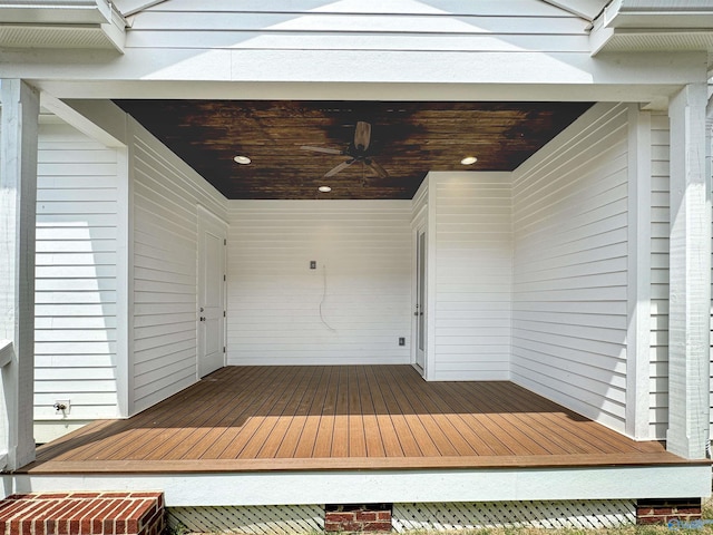 wooden deck featuring ceiling fan