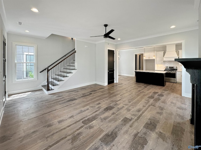 unfurnished living room featuring crown molding, ceiling fan, and wood-type flooring