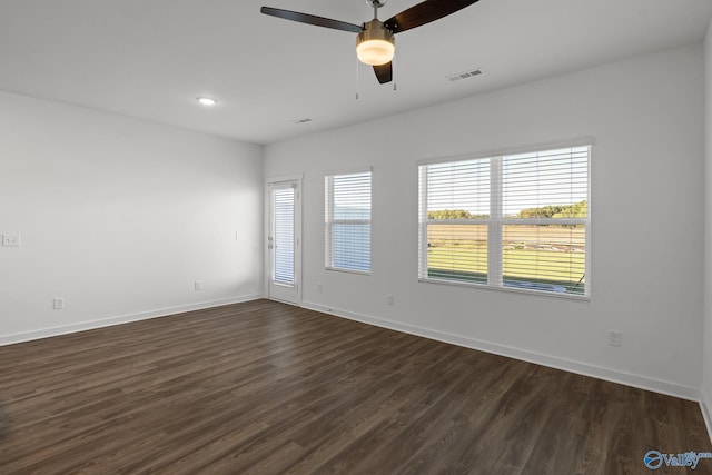 empty room with ceiling fan and dark wood-type flooring