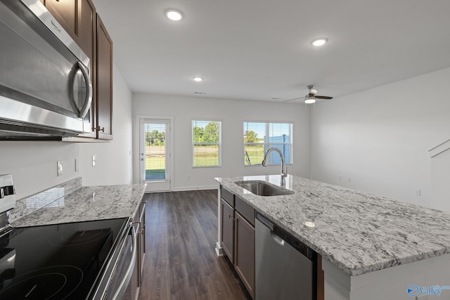 kitchen with sink, ceiling fan, dark hardwood / wood-style floors, a kitchen island with sink, and appliances with stainless steel finishes