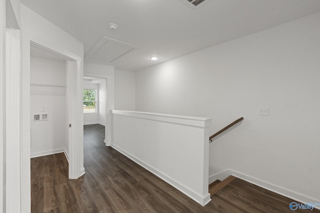 corridor with dark hardwood / wood-style flooring