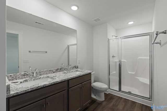 bathroom with toilet, wood-type flooring, walk in shower, and vanity