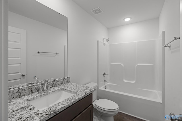 full bathroom with shower / bathtub combination, hardwood / wood-style flooring, vanity, and toilet