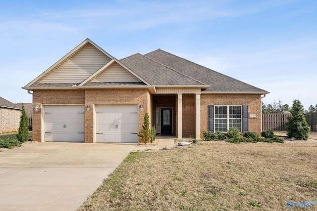 view of front of property featuring a garage and a front lawn