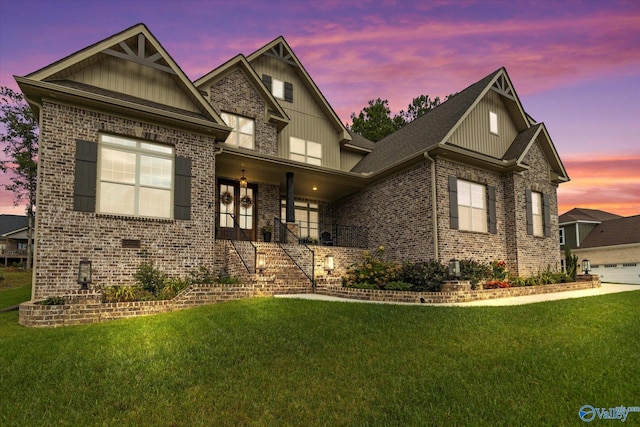 craftsman inspired home featuring a lawn and a garage