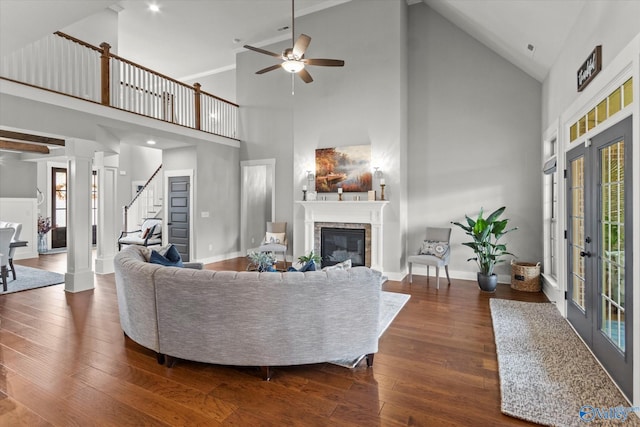 68 Natures Ridge Way, Huntsville, AL 35803 - living room with a glass covered fireplace, high vaulted ceiling, a ceiling fan, dark wood-style floors, and stairs
