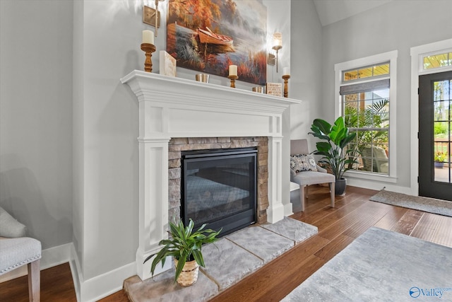 68 Natures Ridge Way, Huntsville, AL 35803 - living area featuring wood finished floors, a glass covered fireplace, baseboards, and lofted ceiling